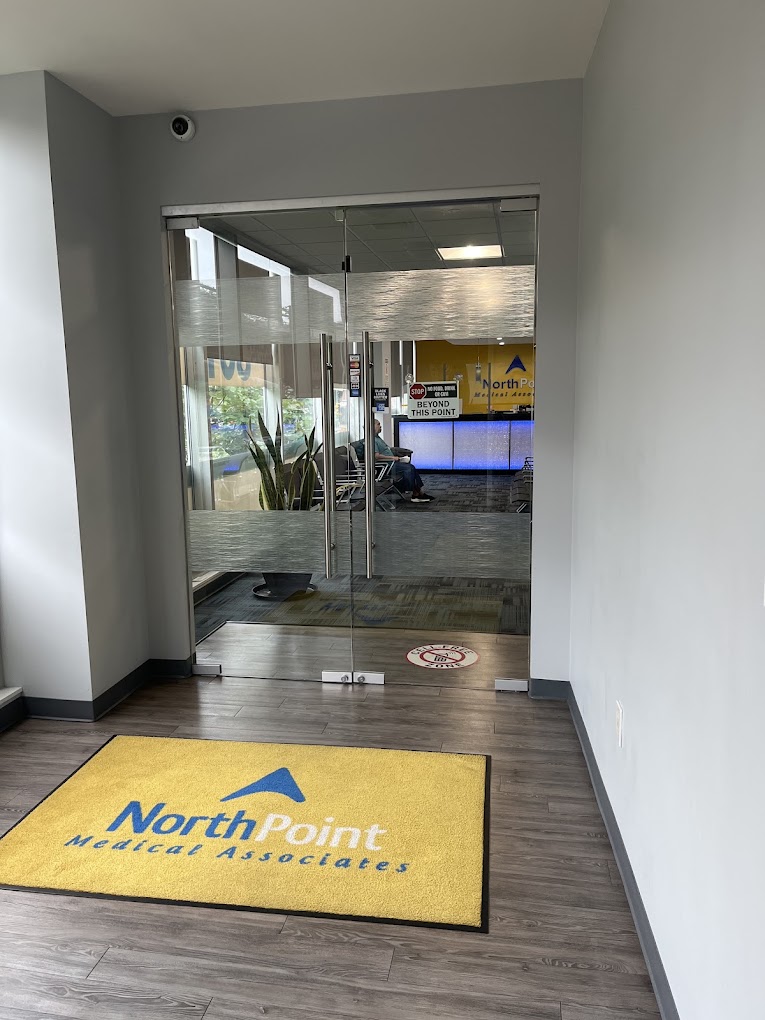 The NorthPoint entrance with glass doors and a yellow welcome mat